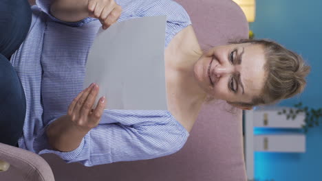Vertical-video-of-The-woman-who-rejoices-in-good-content-paperwork.